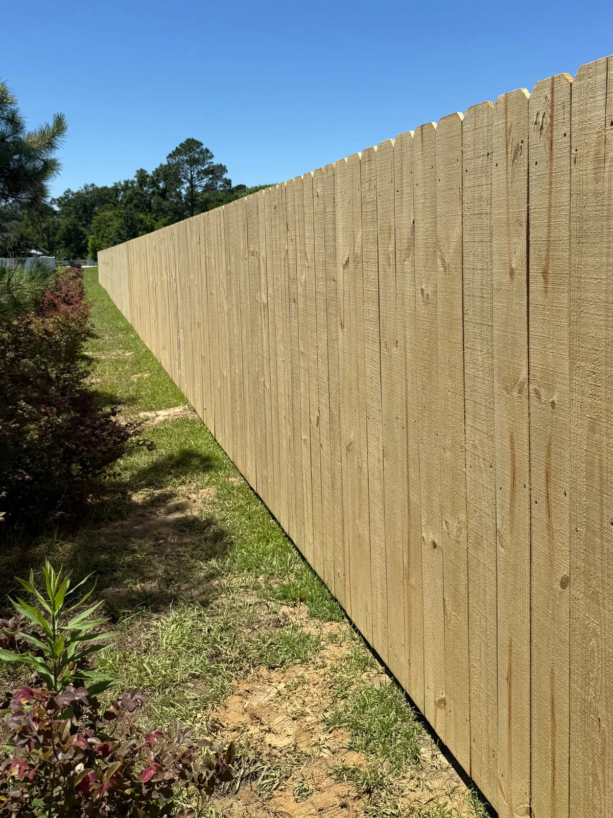New wood privacy fence along a residential yard